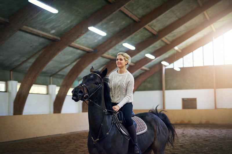 this is a picture of a woman horseback riding